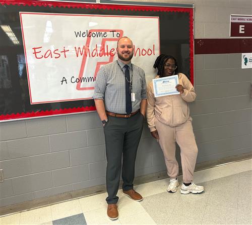 East's October Stairclimber, Davaryhai McLaurin, poses with her certificate and Principal Matt Koval.